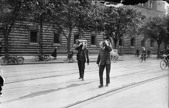 Workers from Nationalbanken carrying sacks of money across the road