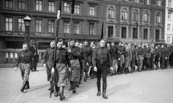 Uniformed Young Conservatives march outside the main train station in Copenhagen